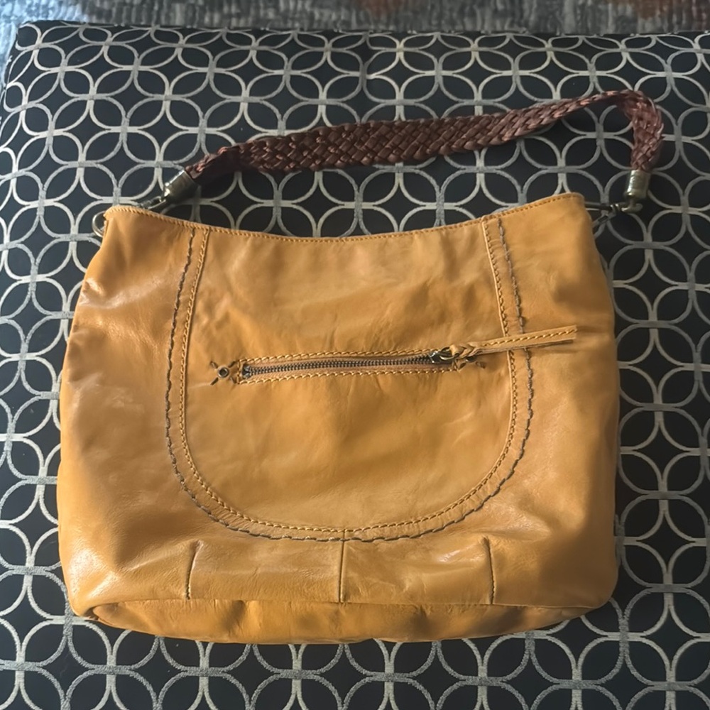 The Sak leather purse.  Nice golden color.  Pockets on outside and inside.